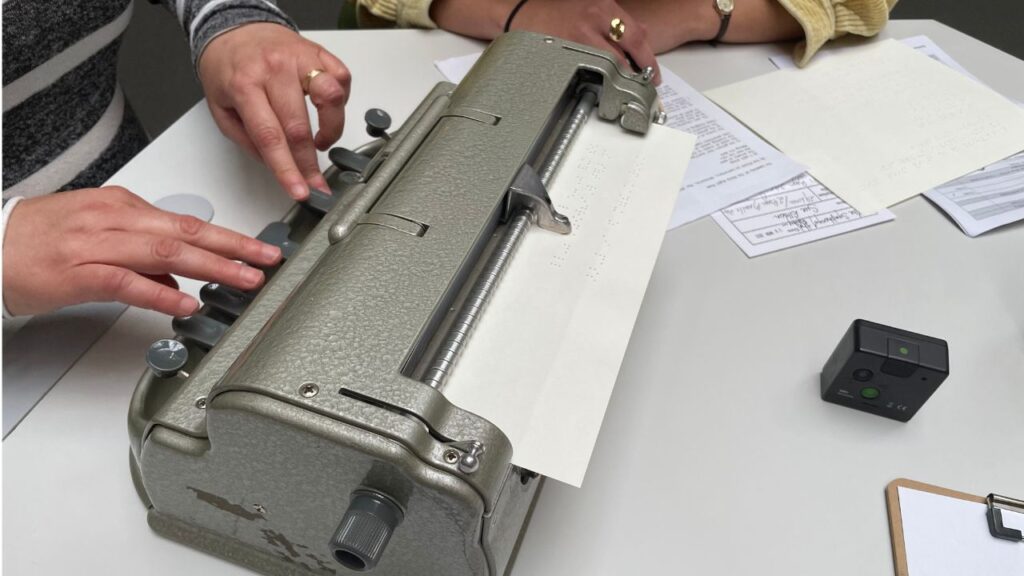 Braille Machine operated by Marisa Sposaro and Caitlyn at In(Visible) Libraries Poetry in Braille Project at State Library of Victoria